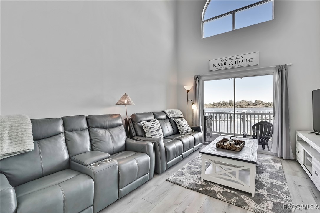 2855 North Rivers Edge Boulevard, Unit 213 Crystal River, FL 34429 - Photo 18 of 62 a living room with furniture and a large window