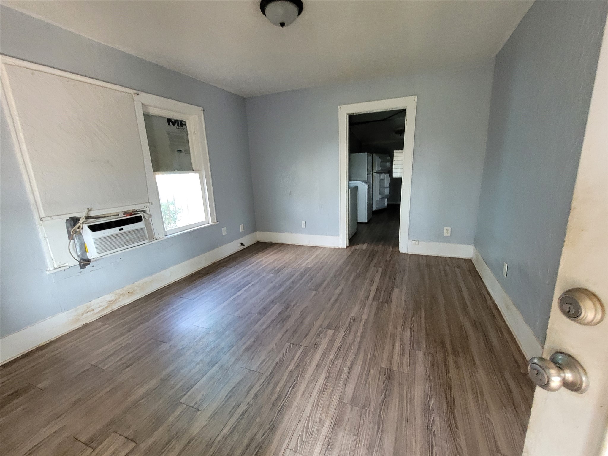 4512 Siegel Street Houston, TX 77009 - Photo 13 of 18 an empty room with wooden floor and windows
