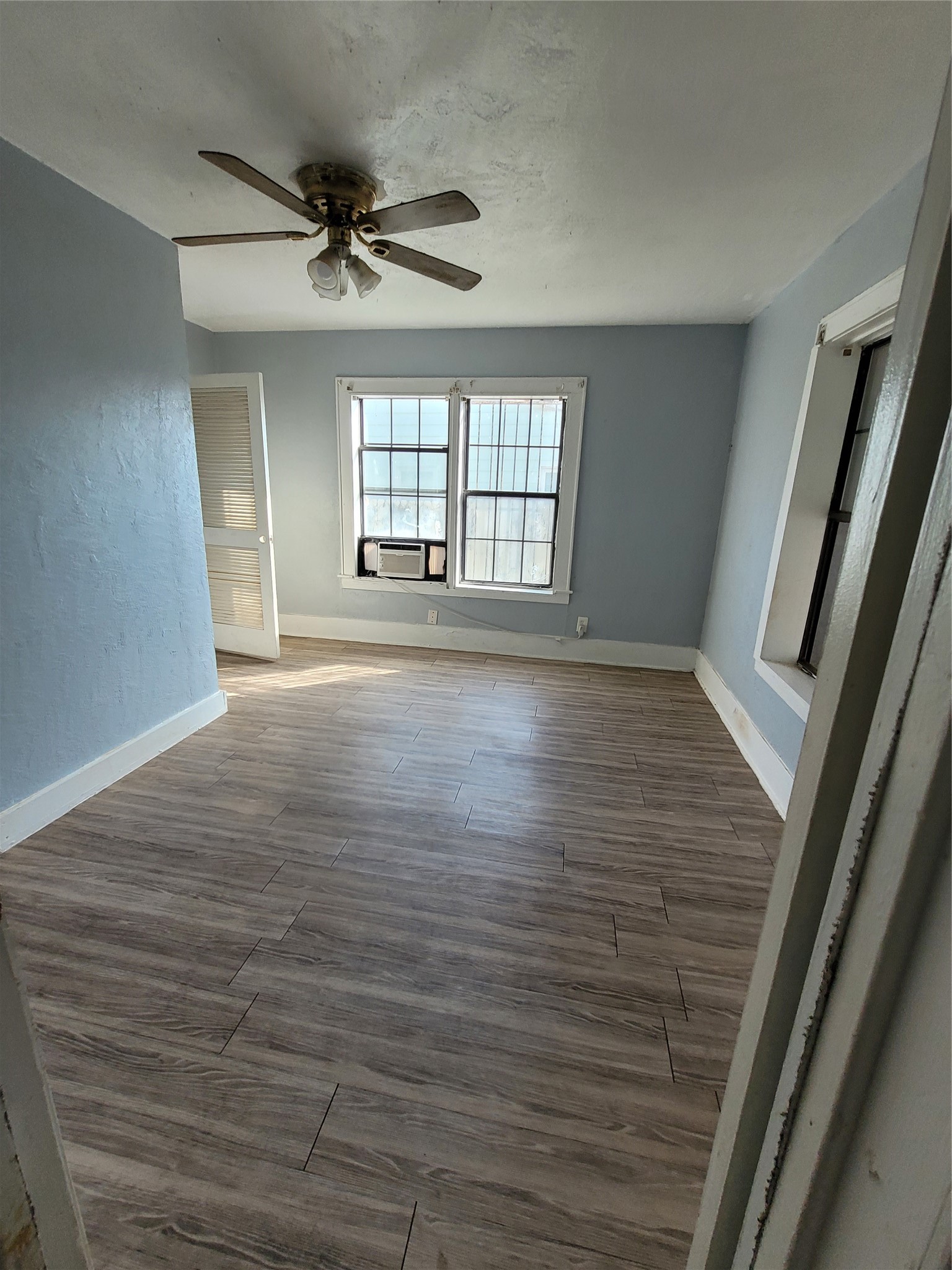 4512 Siegel Street Houston, TX 77009 - Photo 14 of 18 a view of an empty room with a window and wooden floor