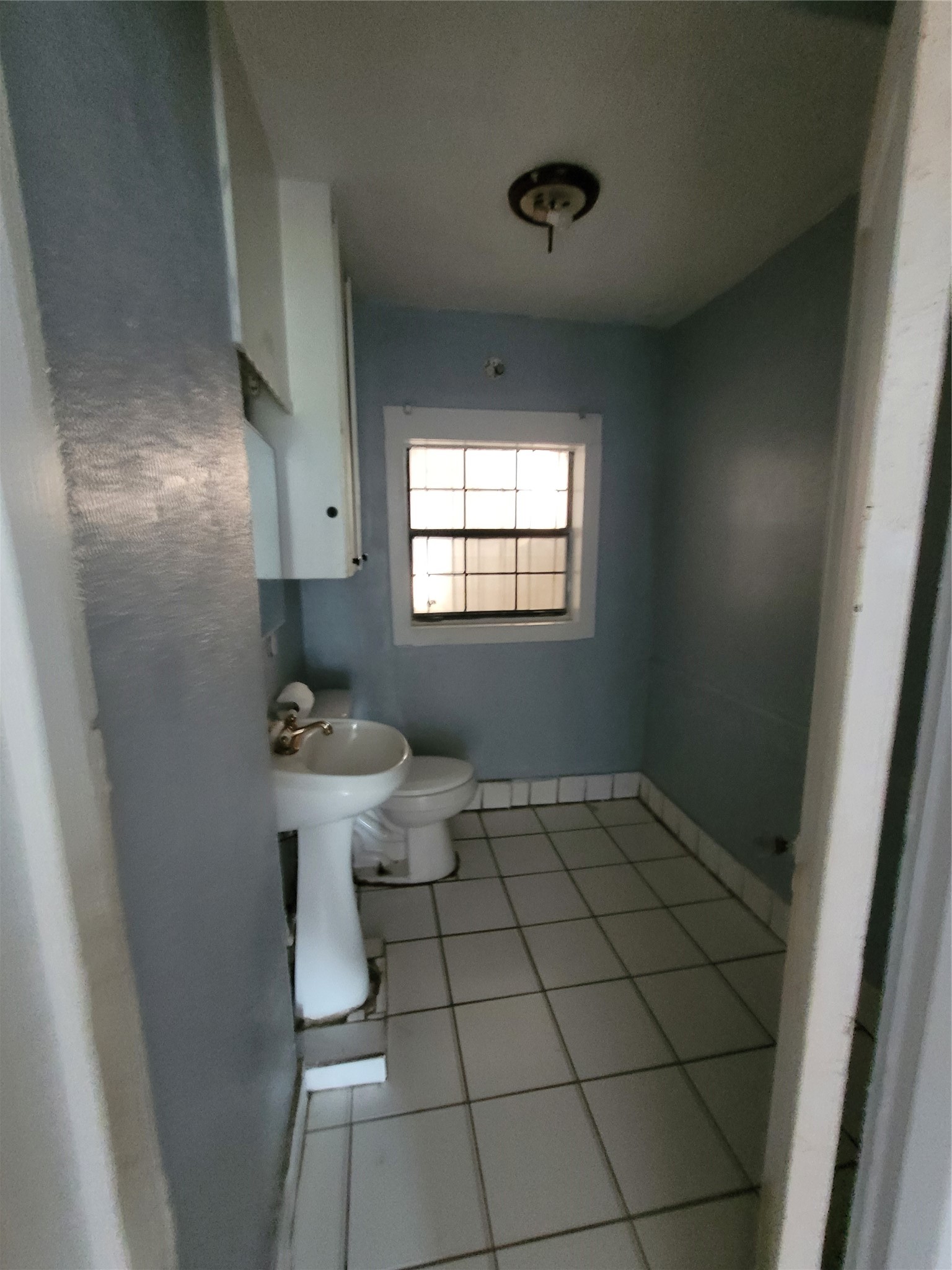 4512 Siegel Street Houston, TX 77009 - Photo 15 of 18 a bathroom with a sink toilet and window