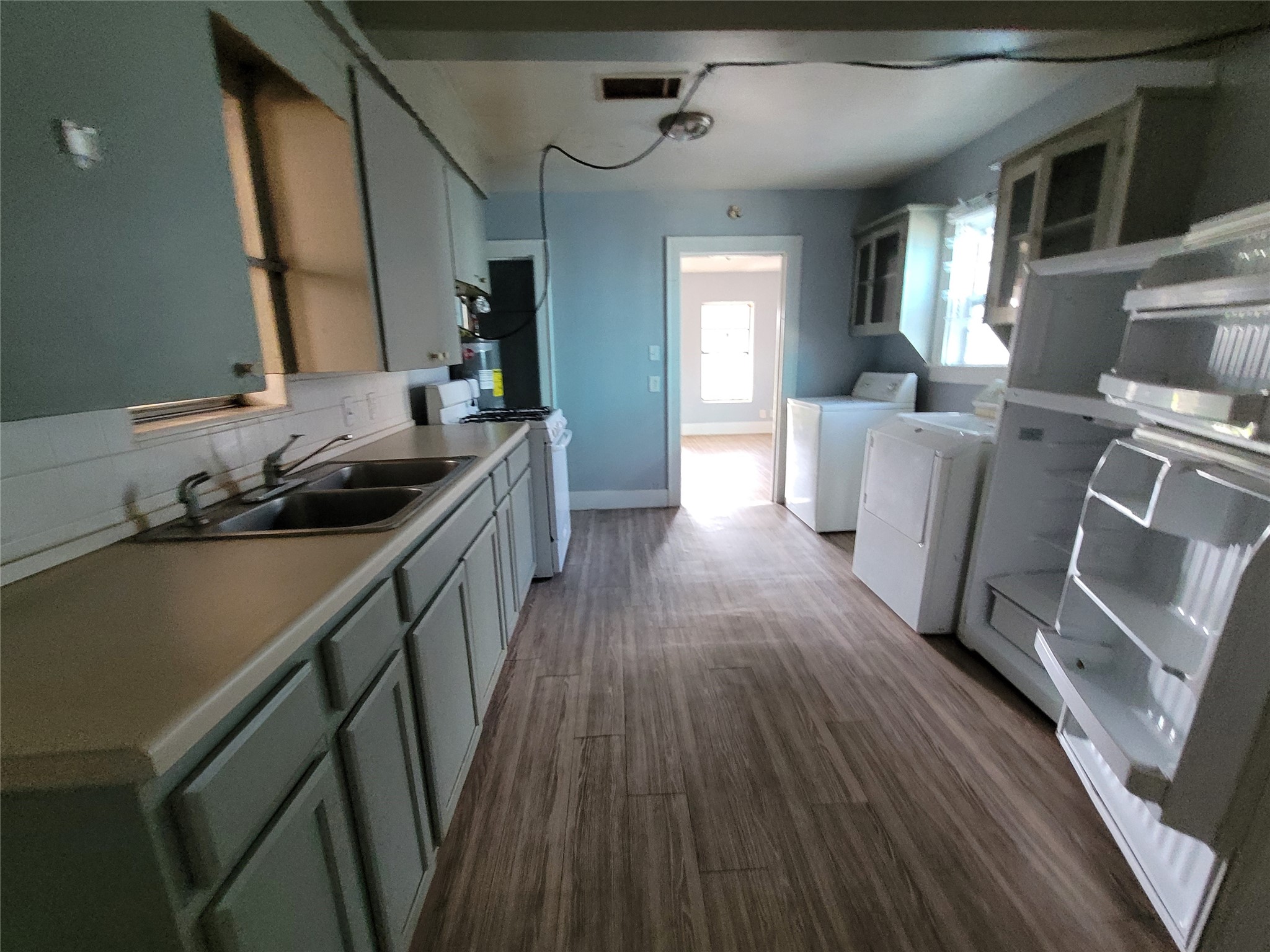 4512 Siegel Street Houston, TX 77009 - Photo 16 of 18 a kitchen with sink stove and cabinets
