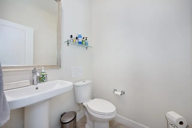 a white toilet sitting next to a bathroom sink