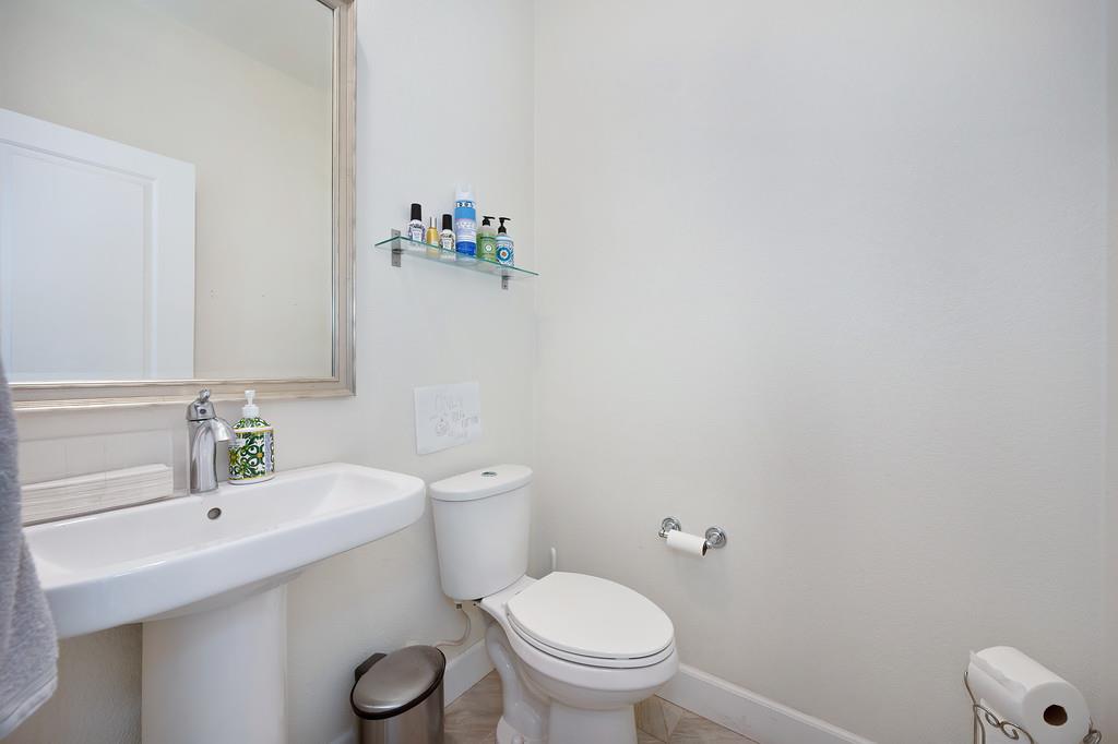 1004 Lavender Street Manteca, CA 95337 - Photo 13 of 35 a white toilet sitting next to a bathroom sink