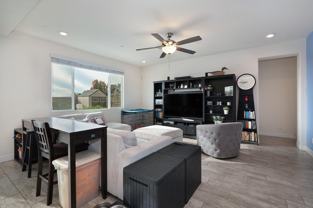 1004 Lavender Street Manteca, CA 95337 - Photo 14 of 35 a living room with furniture a flat screen tv and a fireplace