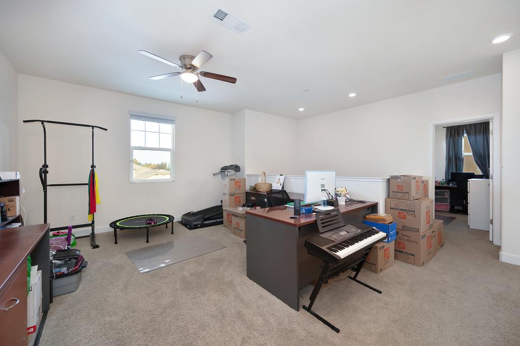 1004 Lavender Street Manteca, CA 95337 - Photo 15 of 35 a view of a workspace with furniture and a window