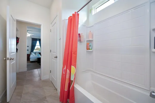 a bathroom with a bathtub and a shower