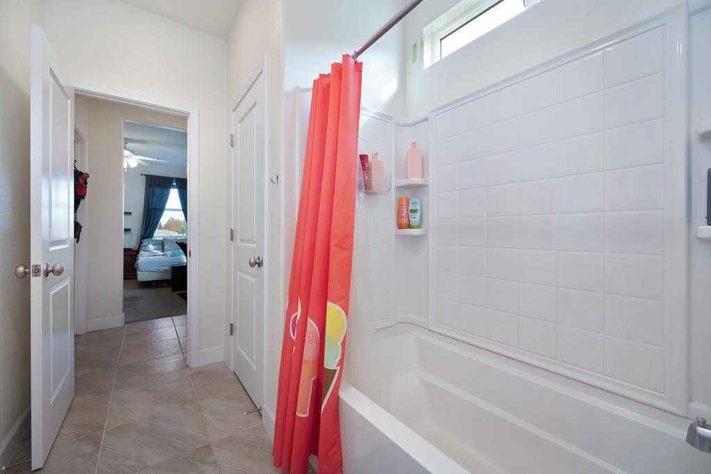 1004 Lavender Street Manteca, CA 95337 - Photo 19 of 35 a bathroom with a bathtub and a shower