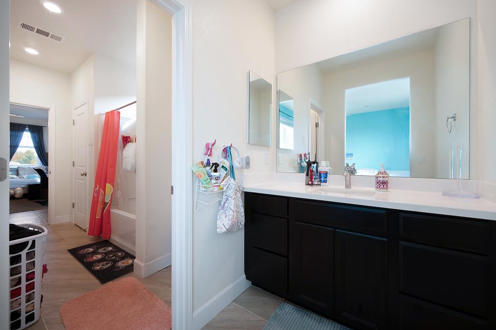 1004 Lavender Street Manteca, CA 95337 - Photo 20 of 35 a bathroom with a sink and a mirror