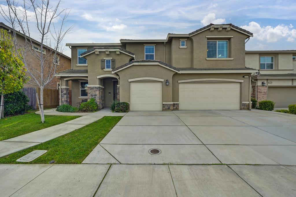1004 Lavender Street Manteca, CA 95337 - Photo 2 of 35 a front view of a house with a yard and garage
