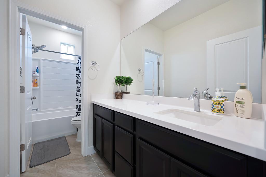 1004 Lavender Street Manteca, CA 95337 - Photo 22 of 35 a bathroom with a sink and a mirror