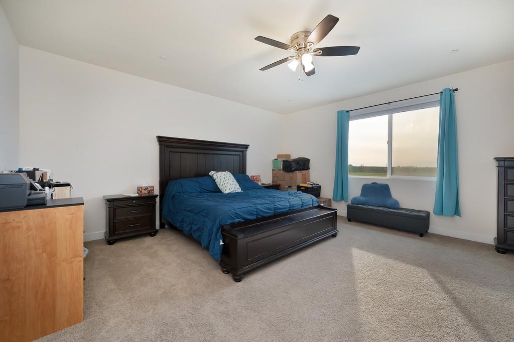 1004 Lavender Street Manteca, CA 95337 - Photo 25 of 35 a bedroom with a bed and glass window