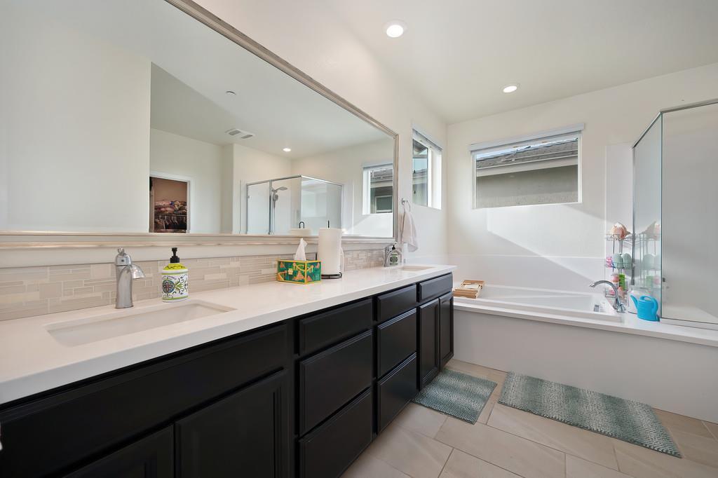 1004 Lavender Street Manteca, CA 95337 - Photo 27 of 35 a bathroom with a tub a sink and mirror