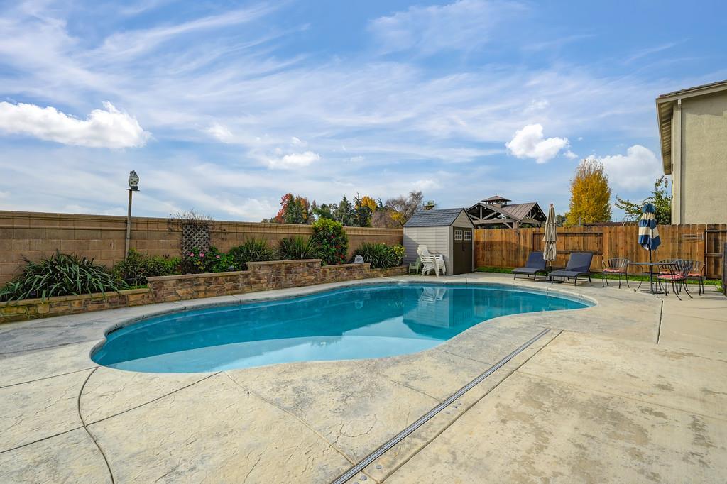 1004 Lavender Street Manteca, CA 95337 - Photo 32 of 35 a view of a swimming pool and a chairs