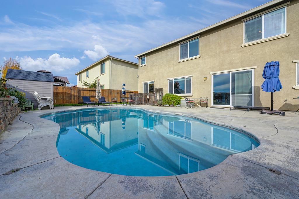 1004 Lavender Street Manteca, CA 95337 - Photo 34 of 35 a view of a house with swimming pool and sitting area