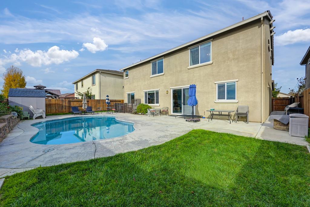 1004 Lavender Street Manteca, CA 95337 - Photo 35 of 35 a view of a house with a backyard porch and sitting area