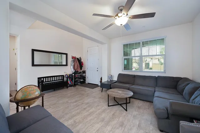 a living room with furniture a air conditioner vent and a window