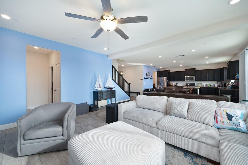 1004 Lavender Street Manteca, CA 95337 - Photo 10 of 35 a living room with furniture kitchen view and a chandelier