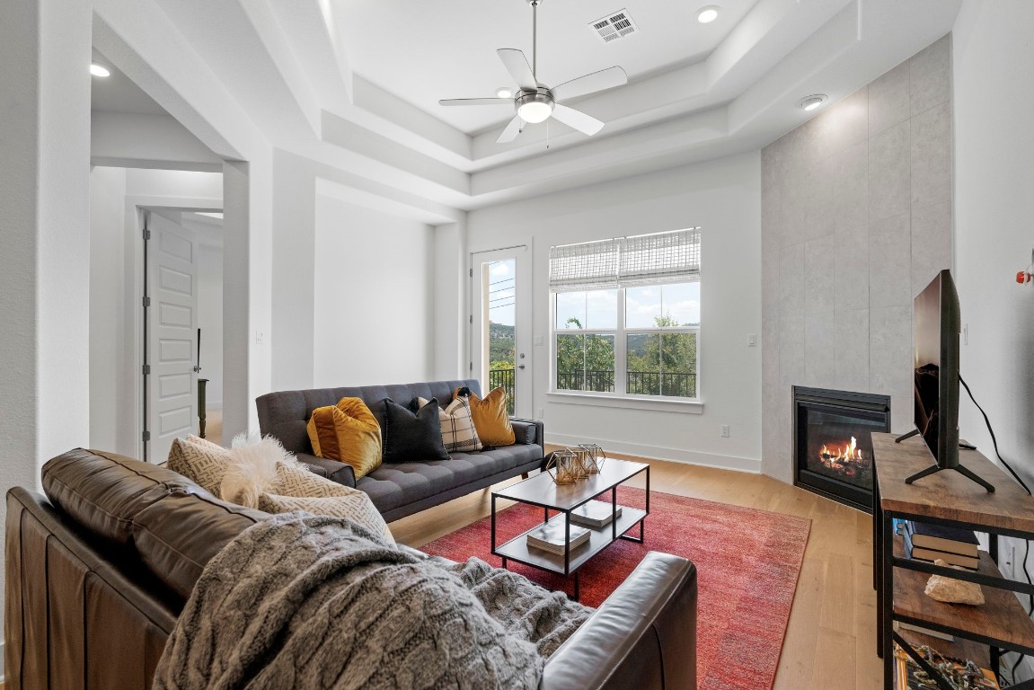 307 Cartwheel Bend Austin, TX 78738 - Photo 11 of 38 a bedroom with furniture and a fireplace