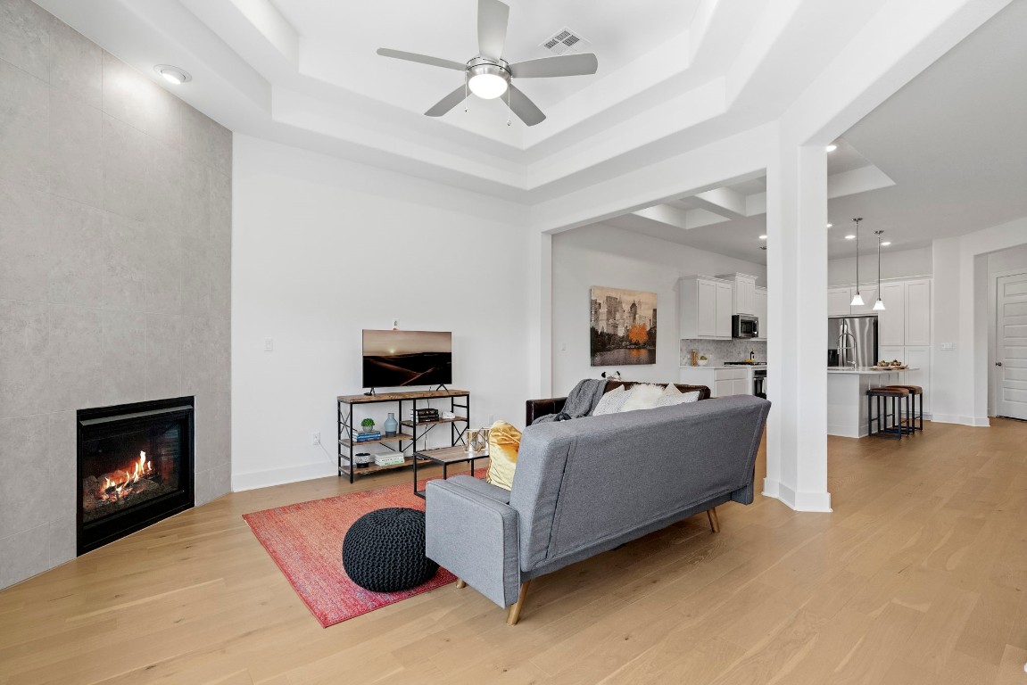 307 Cartwheel Bend Austin, TX 78738 - Photo 12 of 38 a living room with furniture a fireplace and a flat screen tv