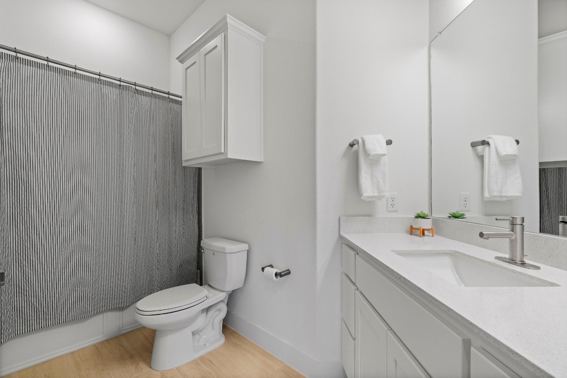 307 Cartwheel Bend Austin, TX 78738 - Photo 13 of 38 a bathroom with a sink a toilet and shower