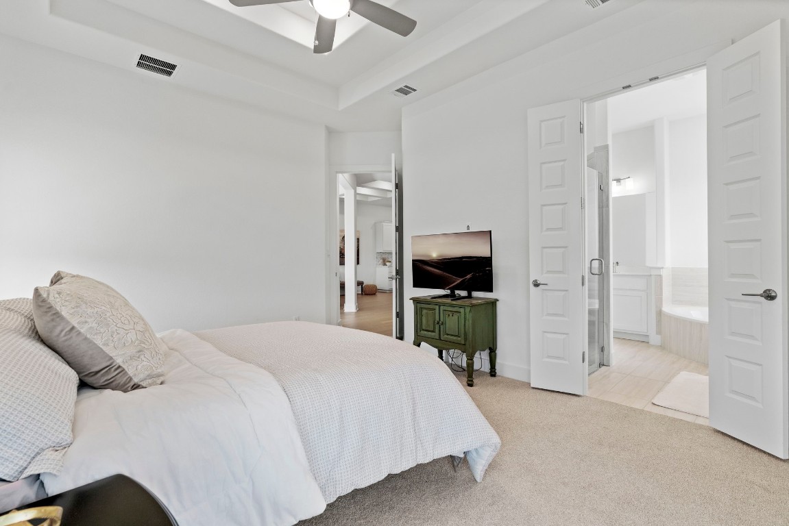 307 Cartwheel Bend Austin, TX 78738 - Photo 20 of 38 a bedroom with a bed and a view of bathroom