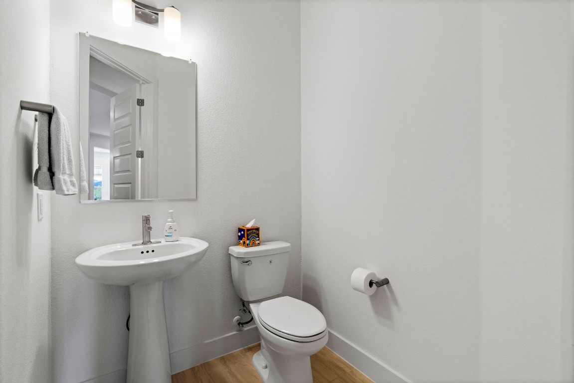 307 Cartwheel Bend Austin, TX 78738 - Photo 25 of 38 a bathroom with a toilet sink and mirror