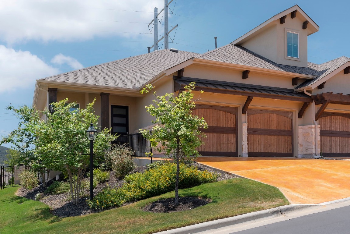 307 Cartwheel Bend Austin, TX 78738 - Photo 4 of 38 a front view of a house with a yard