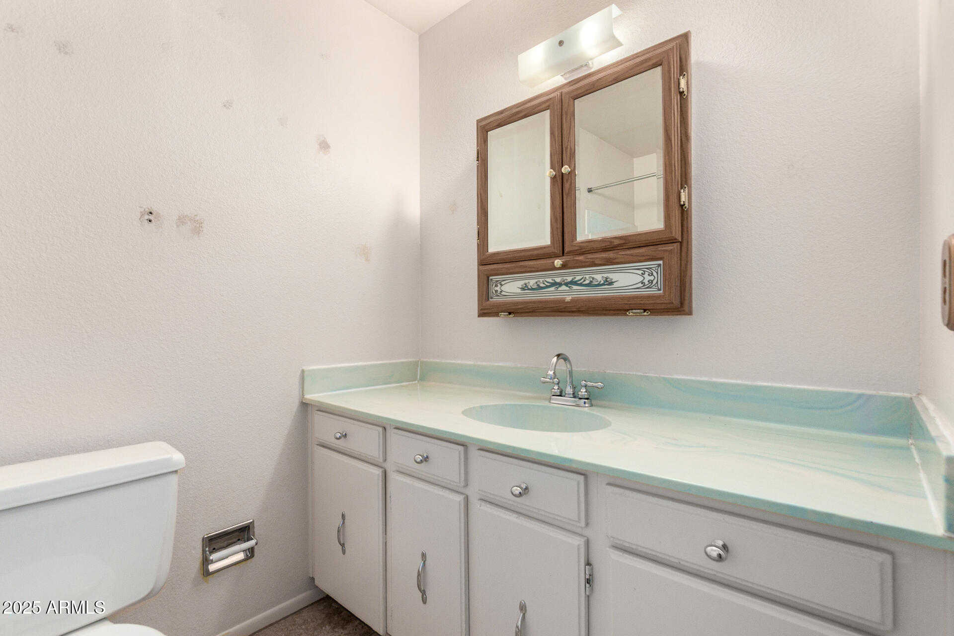 4740 West Bloomfield Road Glendale, AZ 85304 - Photo 25 of 34 a bathroom with a toilet sink vanity and mirror
