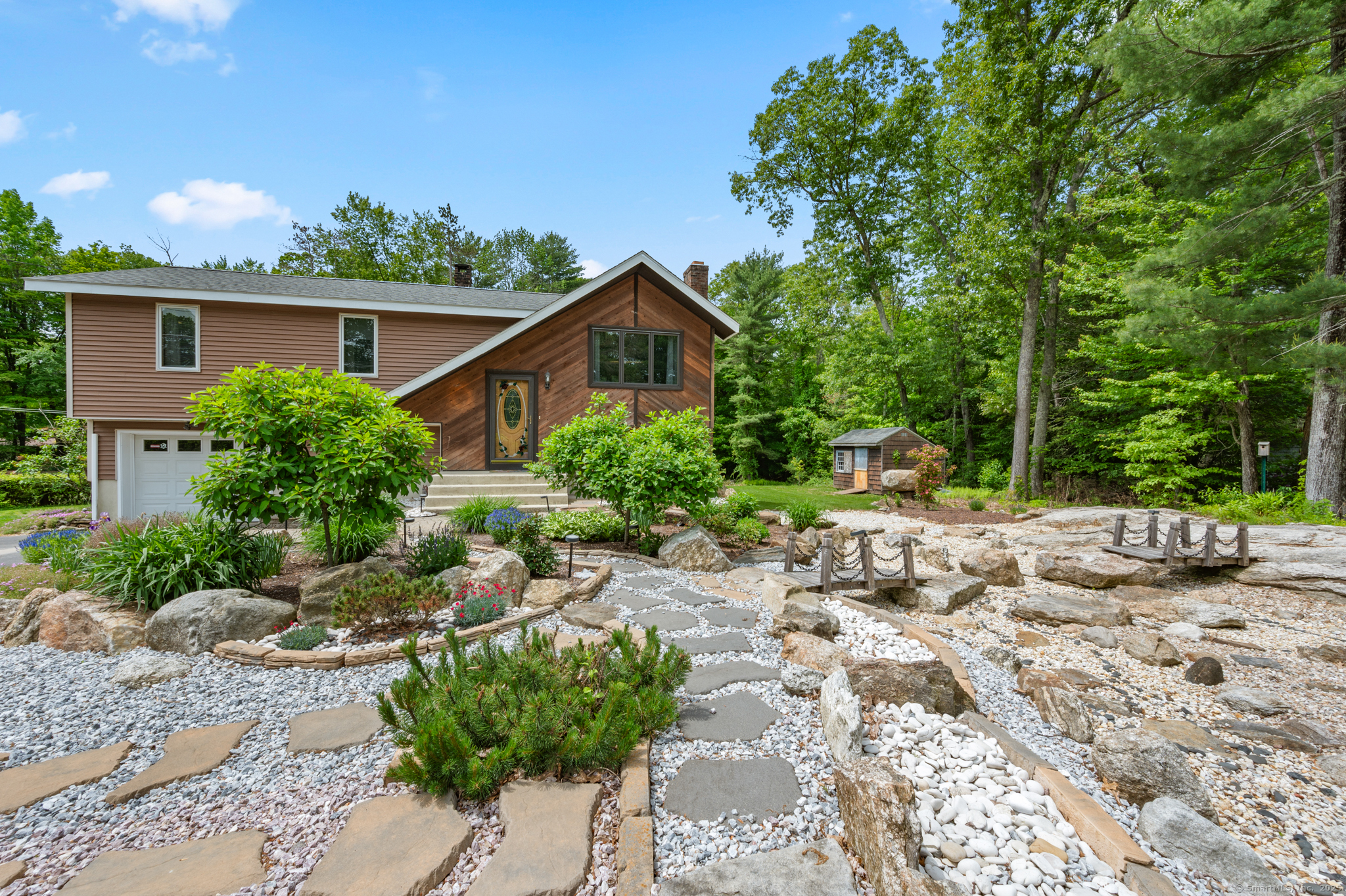 86 Cisar Road Willington, CT 06279 - Photo 1 of 1 a view of a back yard with plants and large trees