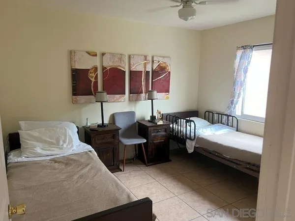 a bedroom with a bed and window