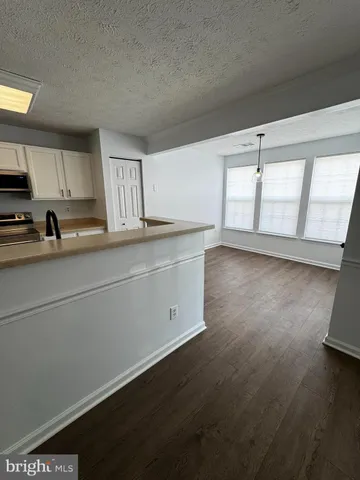 a kitchen with a sink window and cabinets