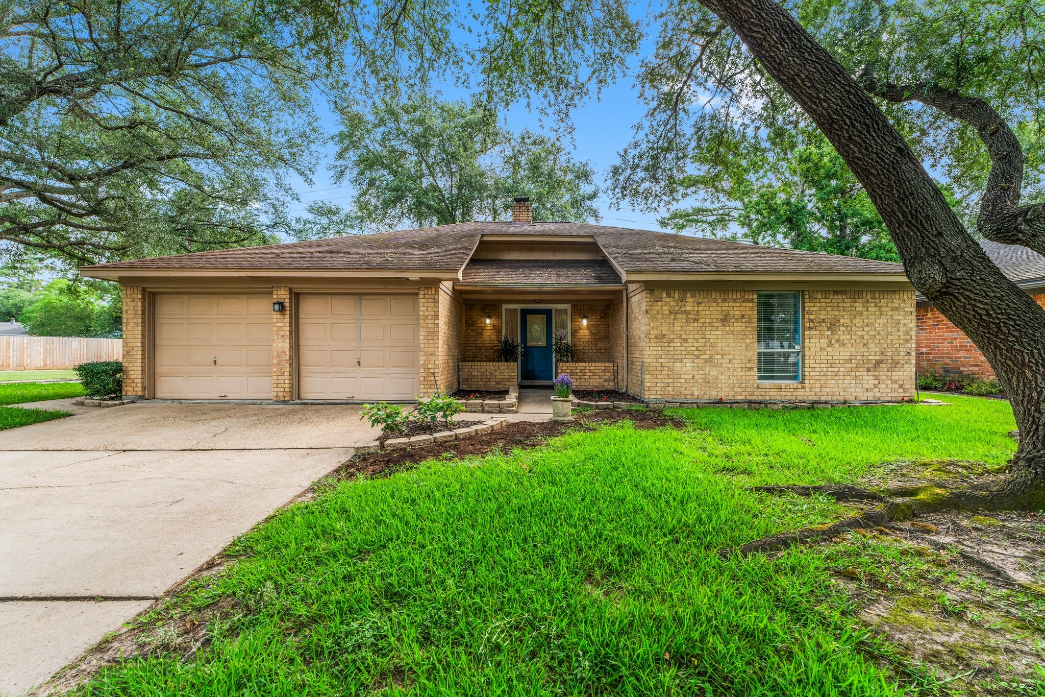 6103 Sunnygate Drive Spring, TX 77373 - Photo 1 of 25 a view of a backyard with a barbeque grill and a large tree