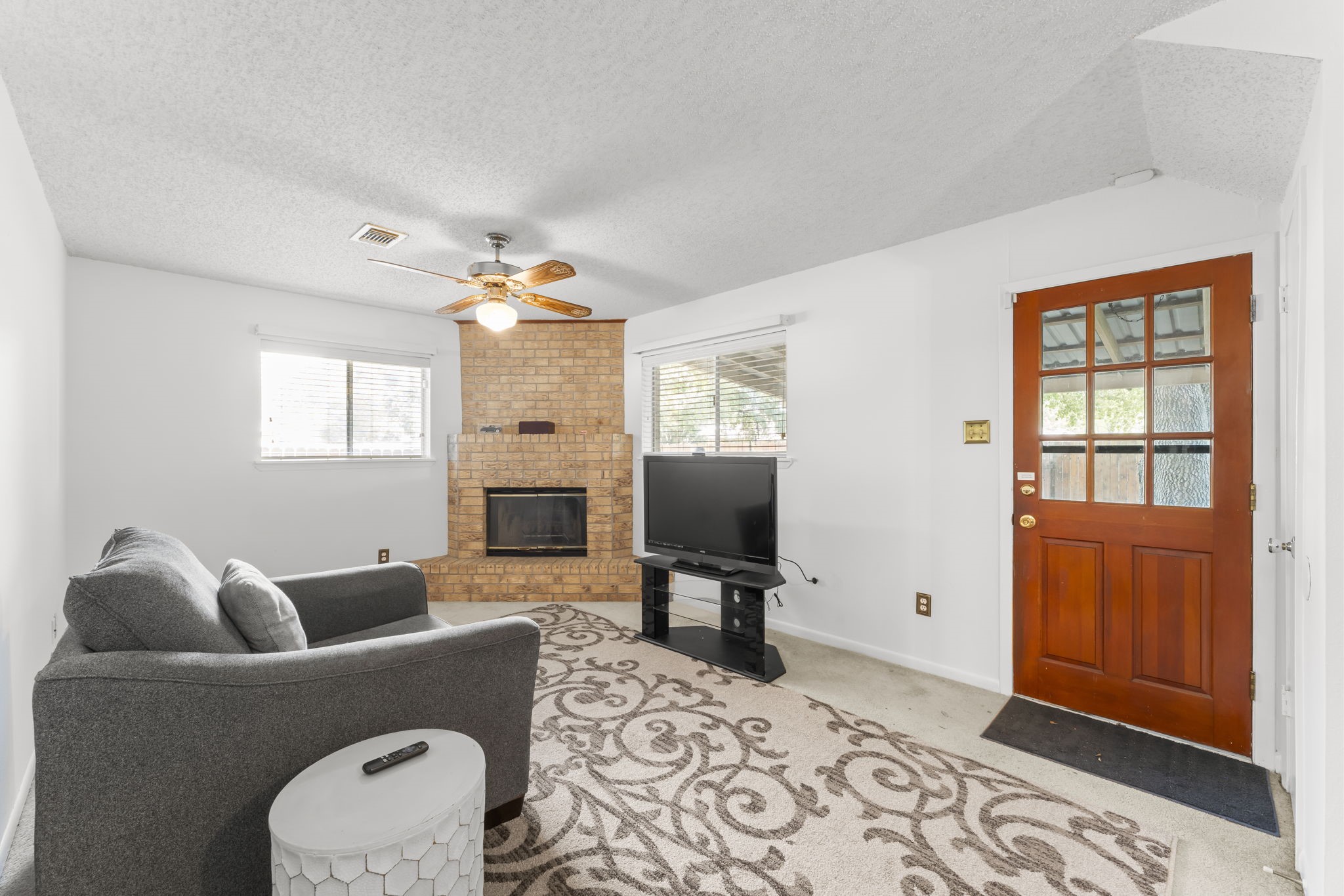 6103 Sunnygate Drive Spring, TX 77373 - Photo 11 of 25 a living room with furniture a window and a flat screen tv