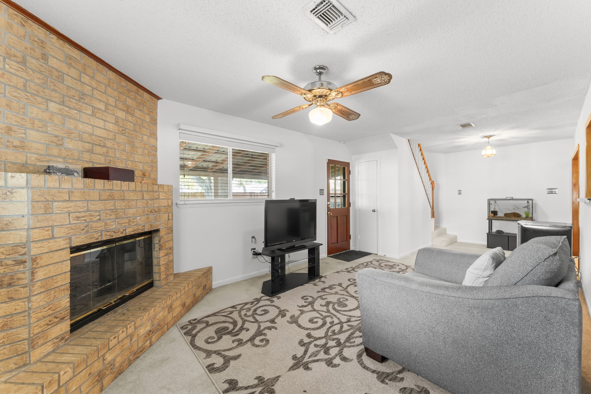 6103 Sunnygate Drive Spring, TX 77373 - Photo 12 of 25 a living room with furniture and a fireplace