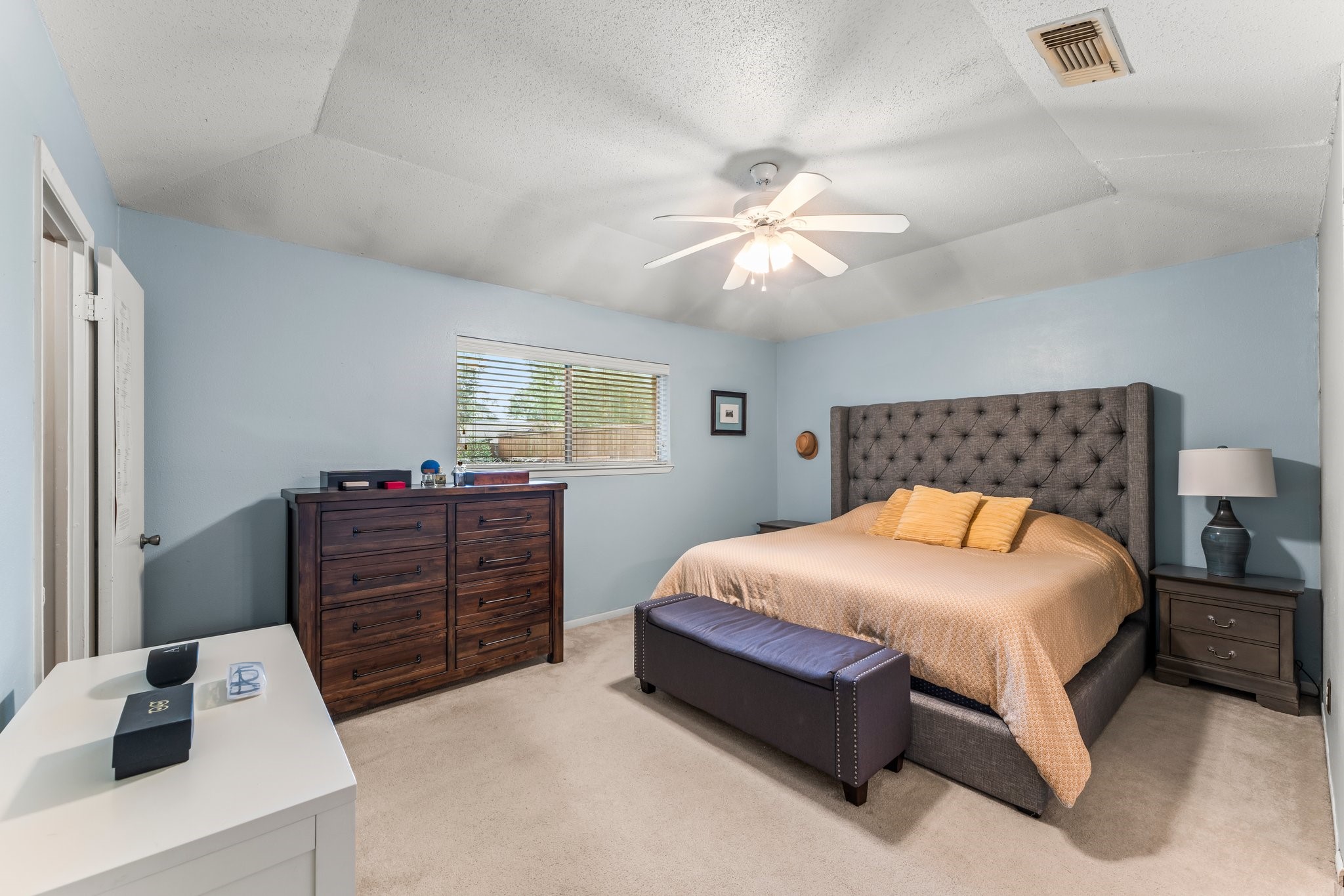 6103 Sunnygate Drive Spring, TX 77373 - Photo 17 of 25 a bedroom with a bed and a chandelier