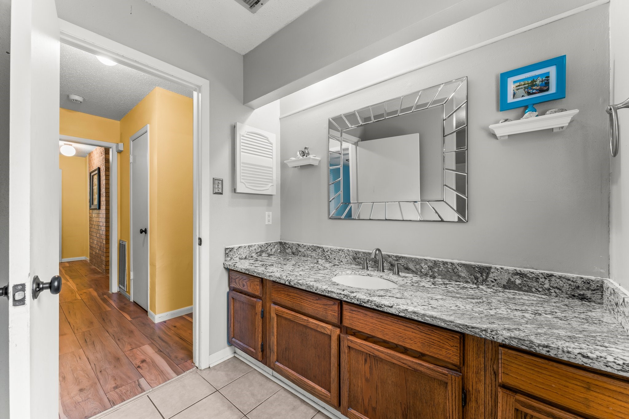 6103 Sunnygate Drive Spring, TX 77373 - Photo 18 of 25 a bathroom with a granite countertop sink and a mirror