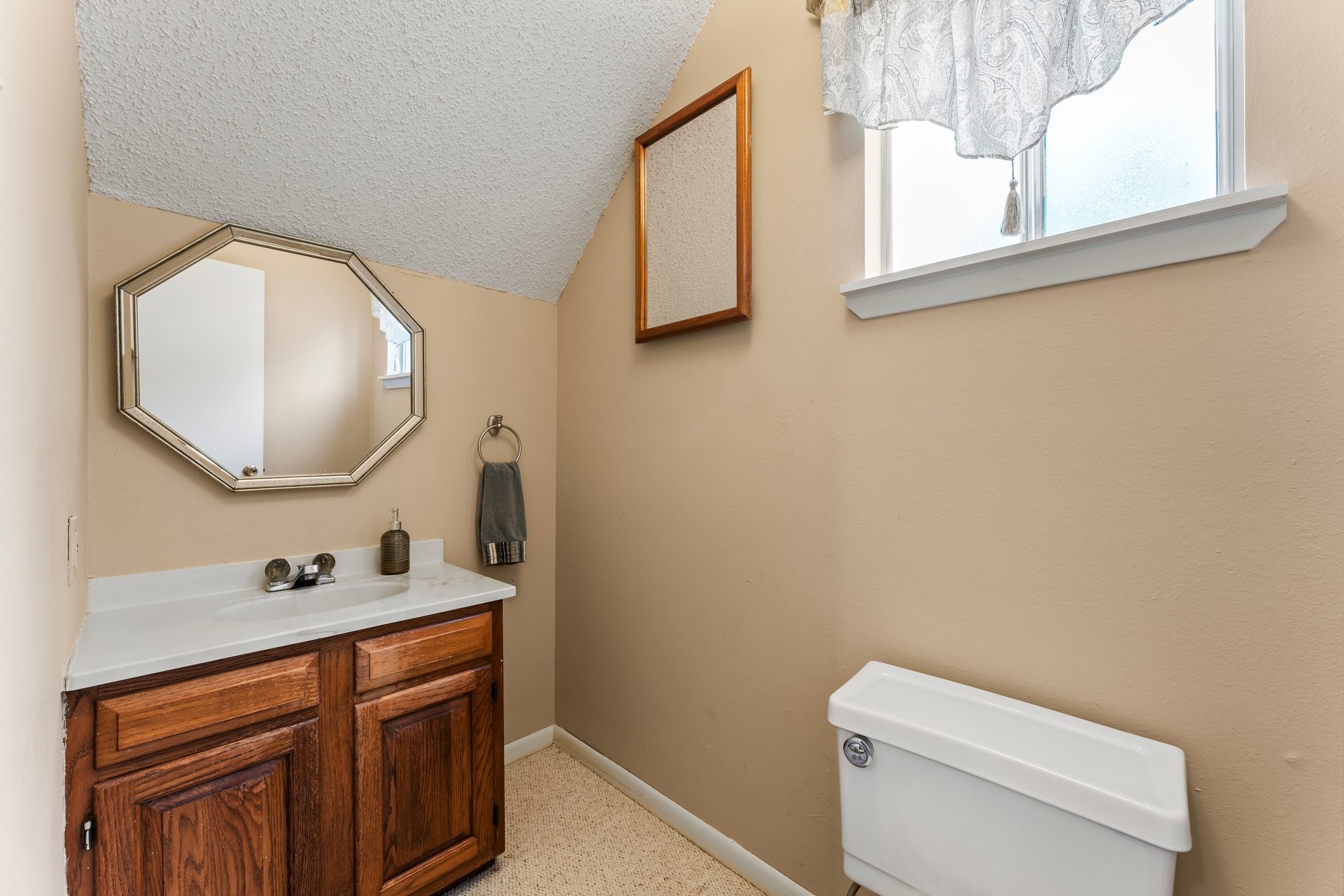 6103 Sunnygate Drive Spring, TX 77373 - Photo 20 of 25 a bathroom with a toilet sink and mirror
