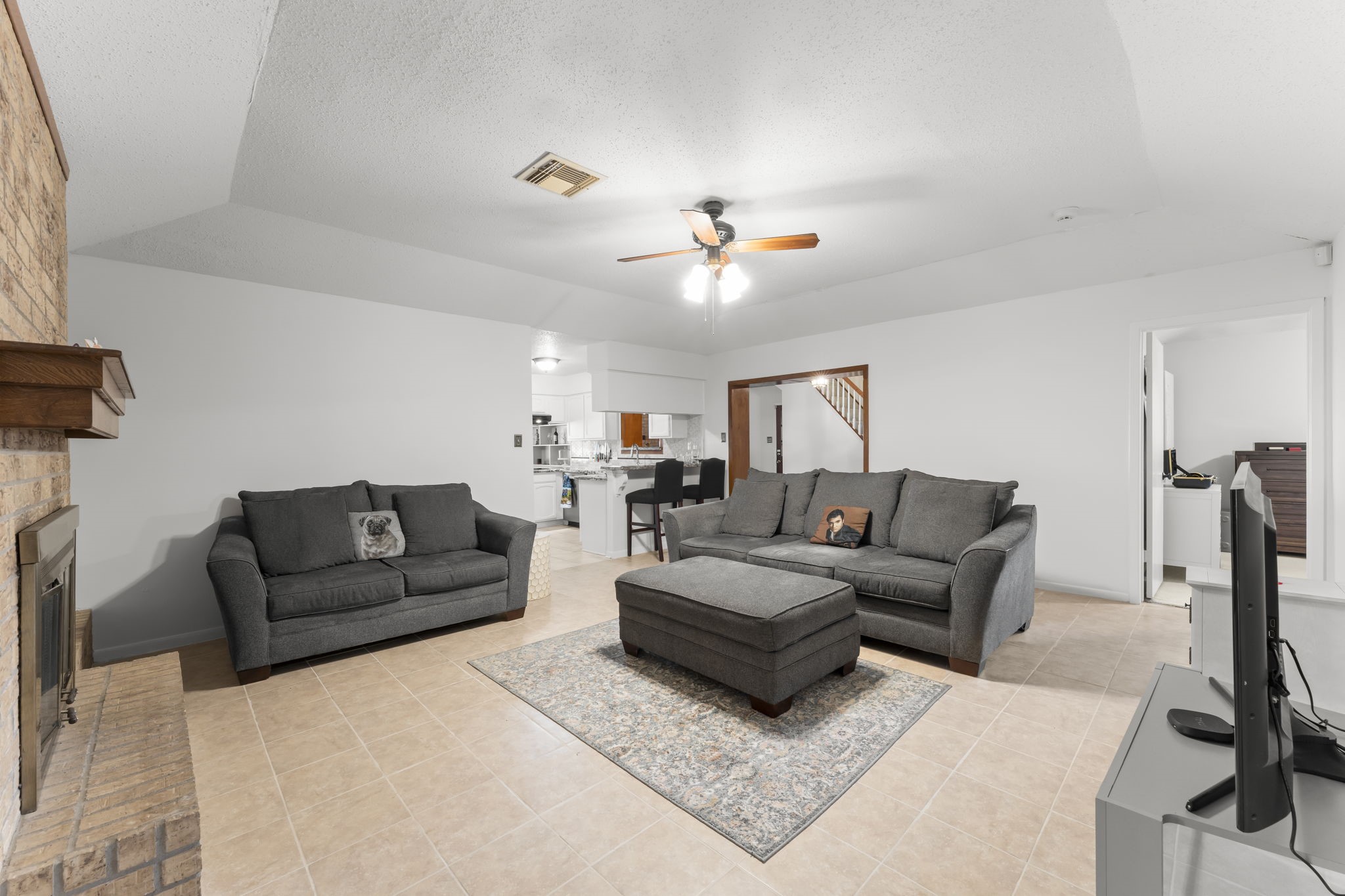 6103 Sunnygate Drive Spring, TX 77373 - Photo 5 of 25 a living room with furniture ceiling fan and a rug