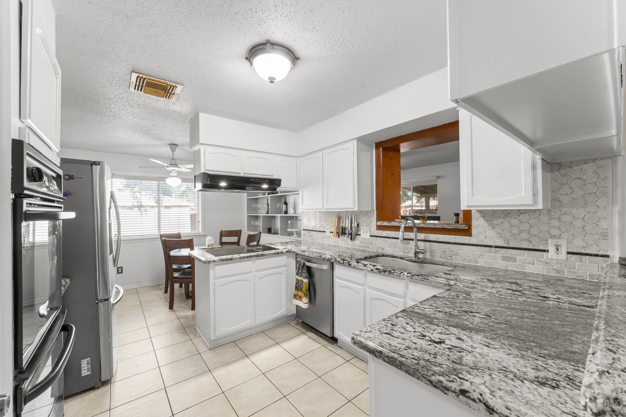 6103 Sunnygate Drive Spring, TX 77373 - Photo 6 of 25 a kitchen with a stove a sink and a refrigerator