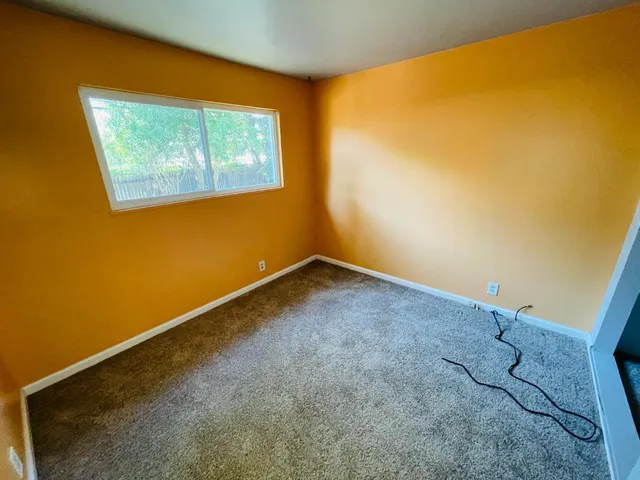 a view of an empty room with a window