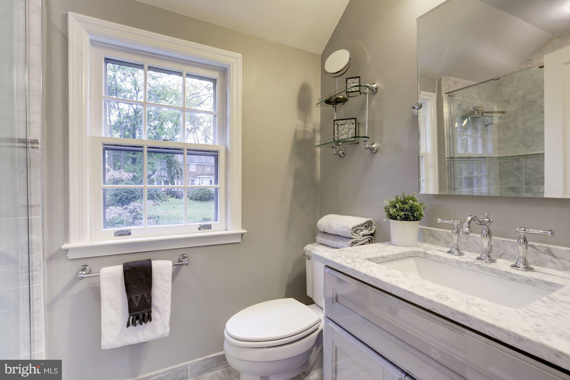 4814 Sedgwick Street Northwest Washington, DC 20016 - Photo 14 of 30 a bathroom with a granite countertop toilet sink and mirror