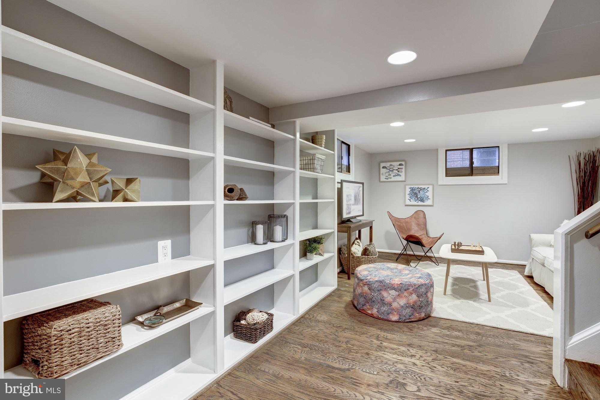 4814 Sedgwick Street Northwest Washington, DC 20016 - Photo 21 of 30 a living room with furniture and a book shelf