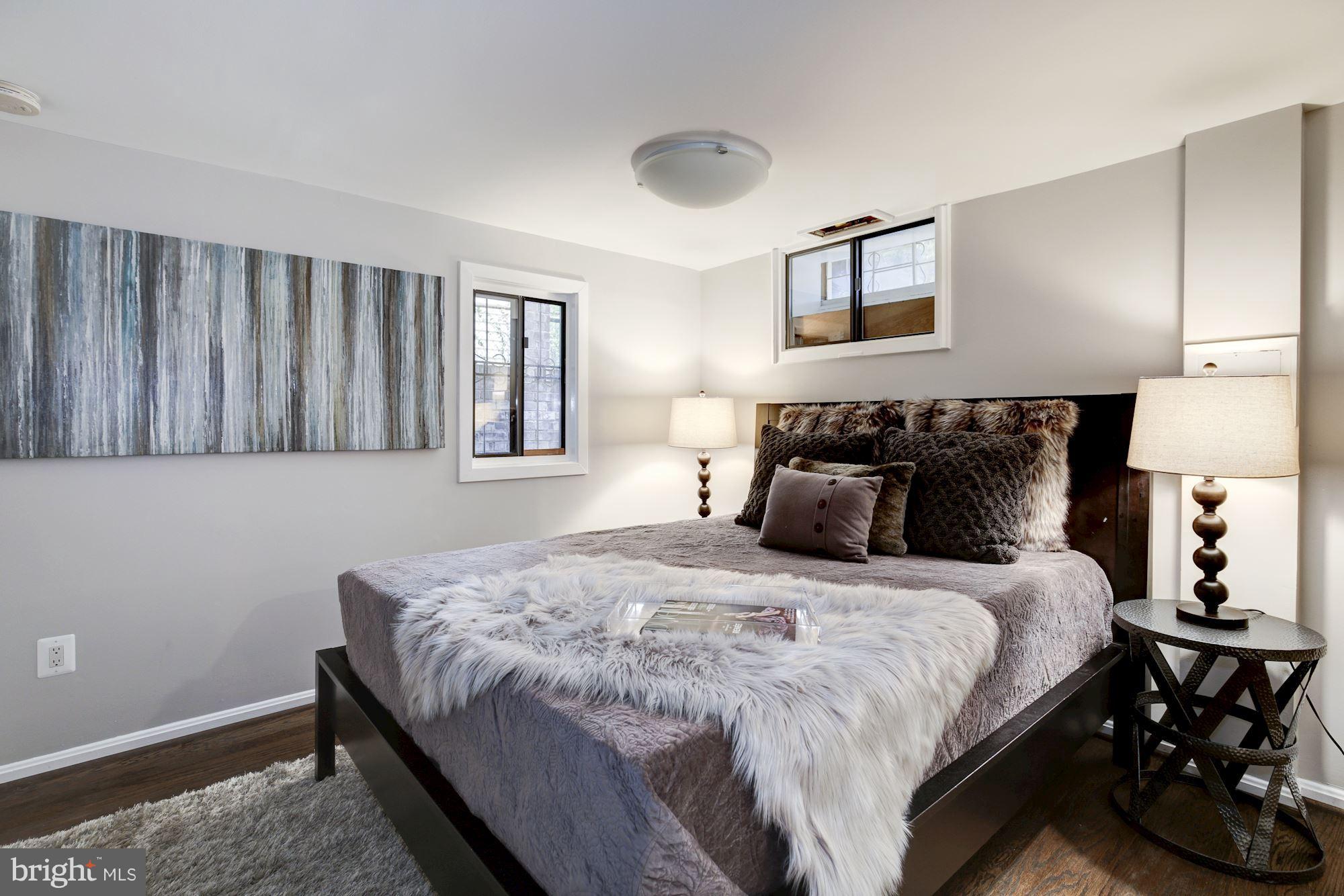 4814 Sedgwick Street Northwest Washington, DC 20016 - Photo 22 of 30 a bedroom with a bed and a night stand