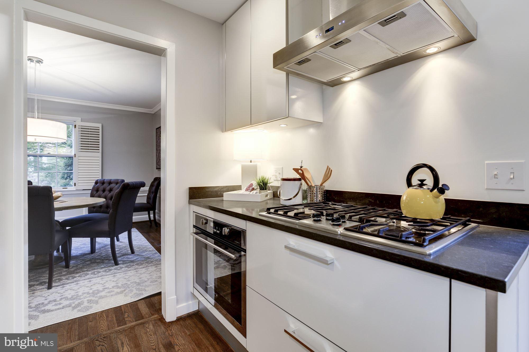 4814 Sedgwick Street Northwest Washington, DC 20016 - Photo 5 of 30 a kitchen with a stove and cabinets