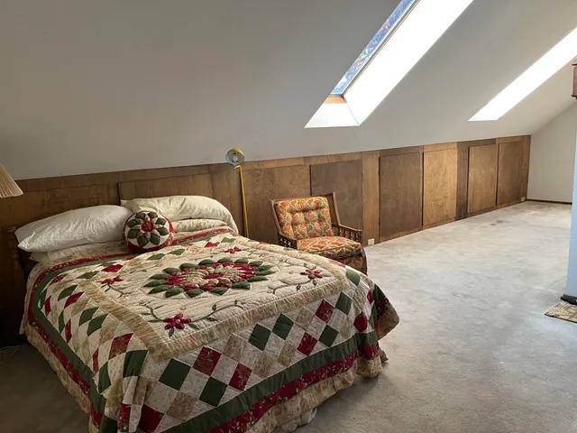 a bedroom with a bed and window