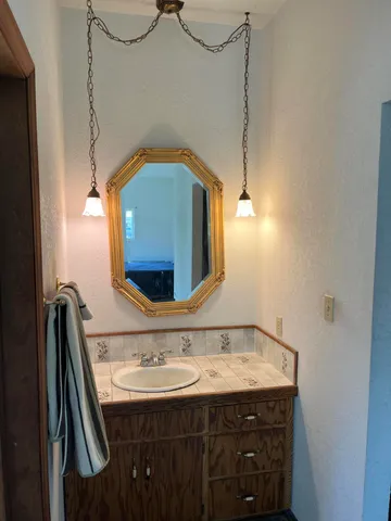 a bathroom with a sink and a mirror