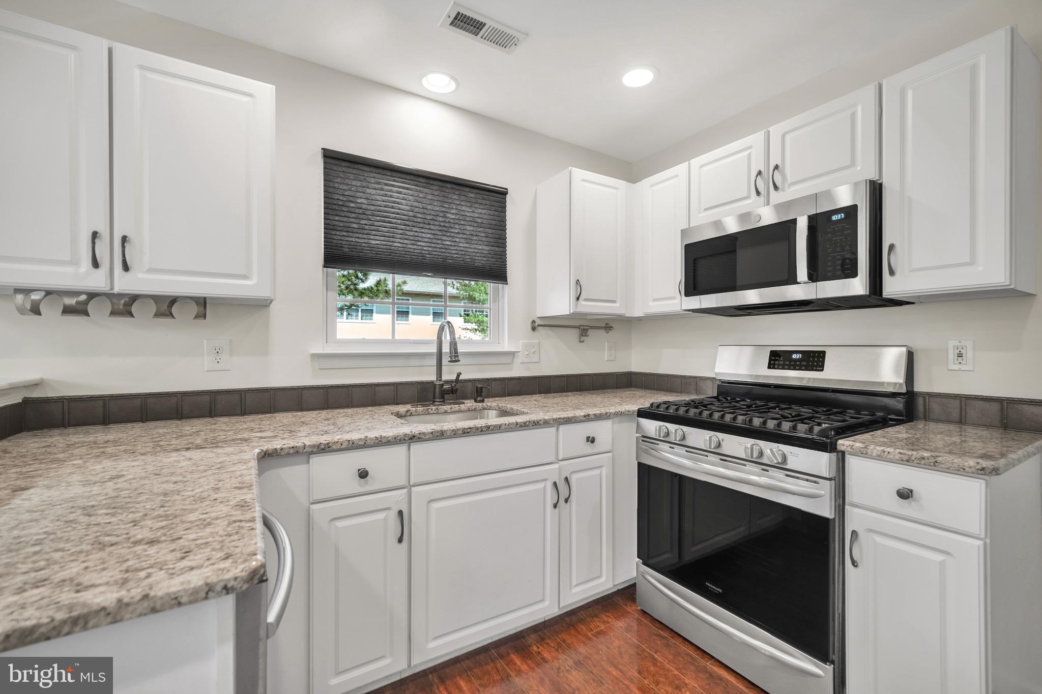 2402 Waterford Road, Unit 94 Yardley, PA 19067 - Photo 8 of 28 a kitchen with granite countertop stainless steel appliances white cabinets granite counter tops and a window