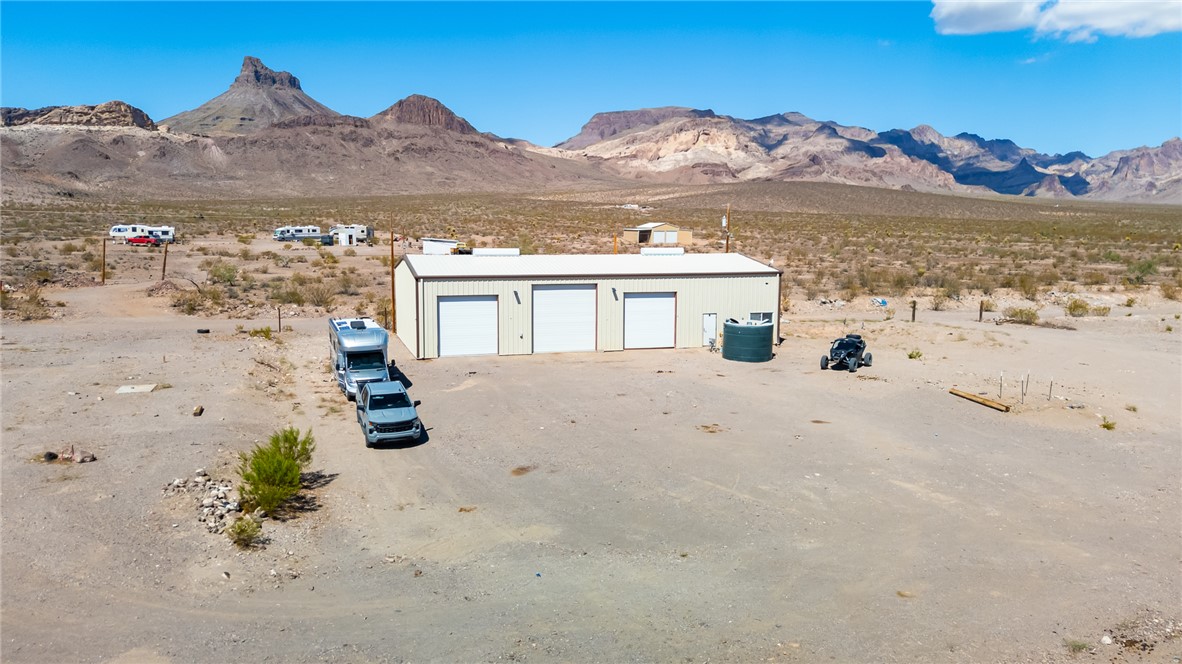 6982 Ocotillo Road Golden Valley, AZ 86413 - Photo 18 of 28 Aerial view of sparsely populated area with a desert landscape and mountains