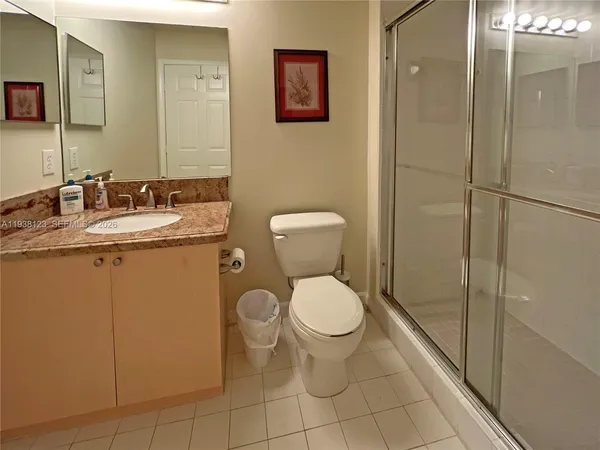 a bathroom with a toilet sink and shower