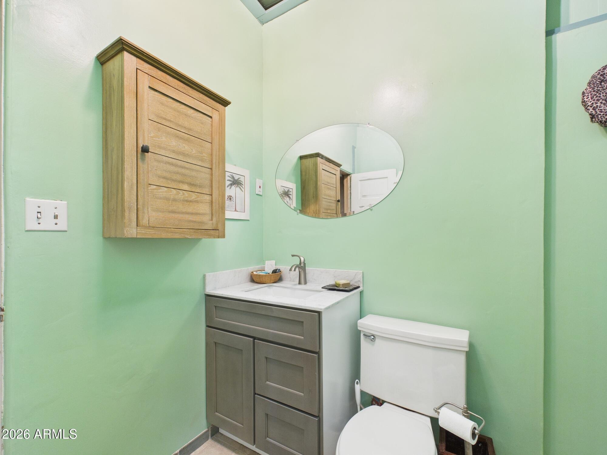198 4th Street Clifton, AZ 85533 - Photo 21 of 30 a bathroom with a toilet sink and mirror